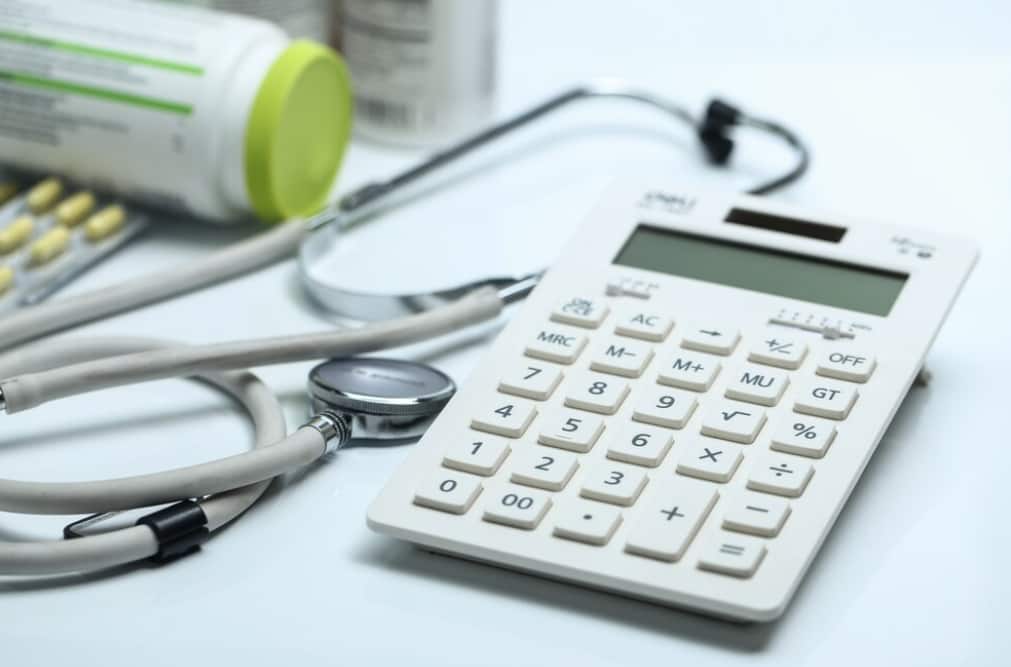 Medical supplies with a calculator and stethoscope on a white background