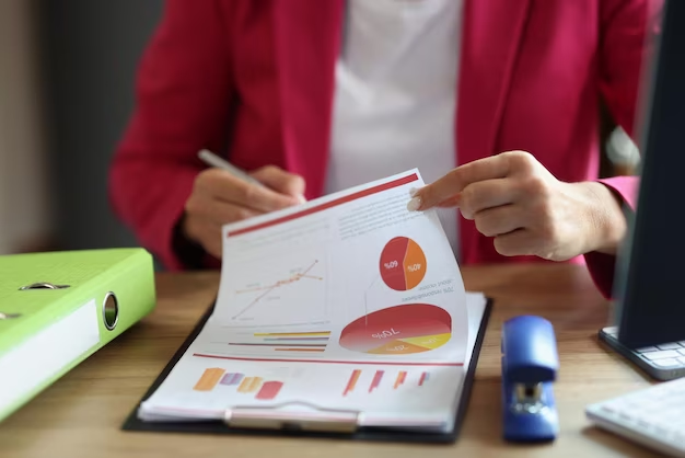 Woman reviewing documents with graphs, charts, and pie charts