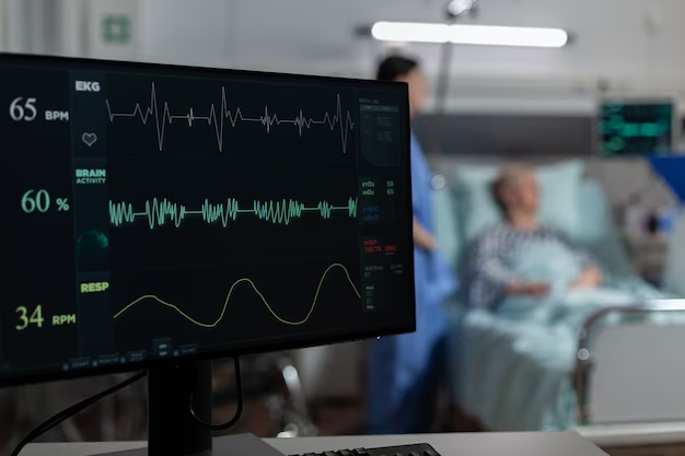 A monitor with vital signs in the background of a hospital