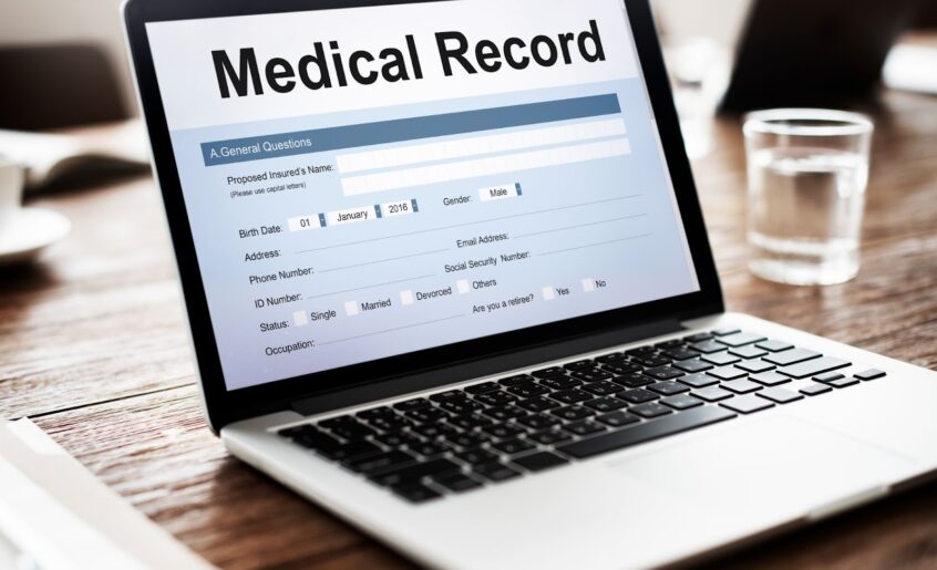 Medical record report document on laptop