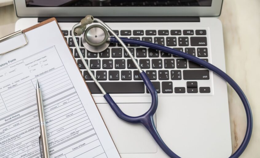 Top view of laptop with stethoscope