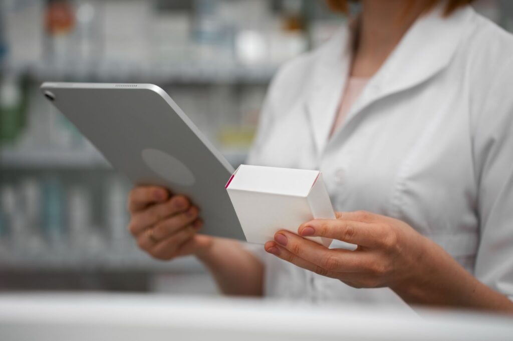 Female pharmacist working with tablet in the pharmacy