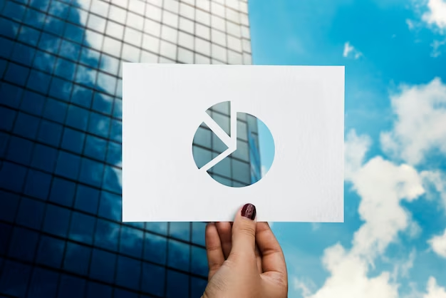 Hand holding a pie chart with a hole, revealing a view of a building outside